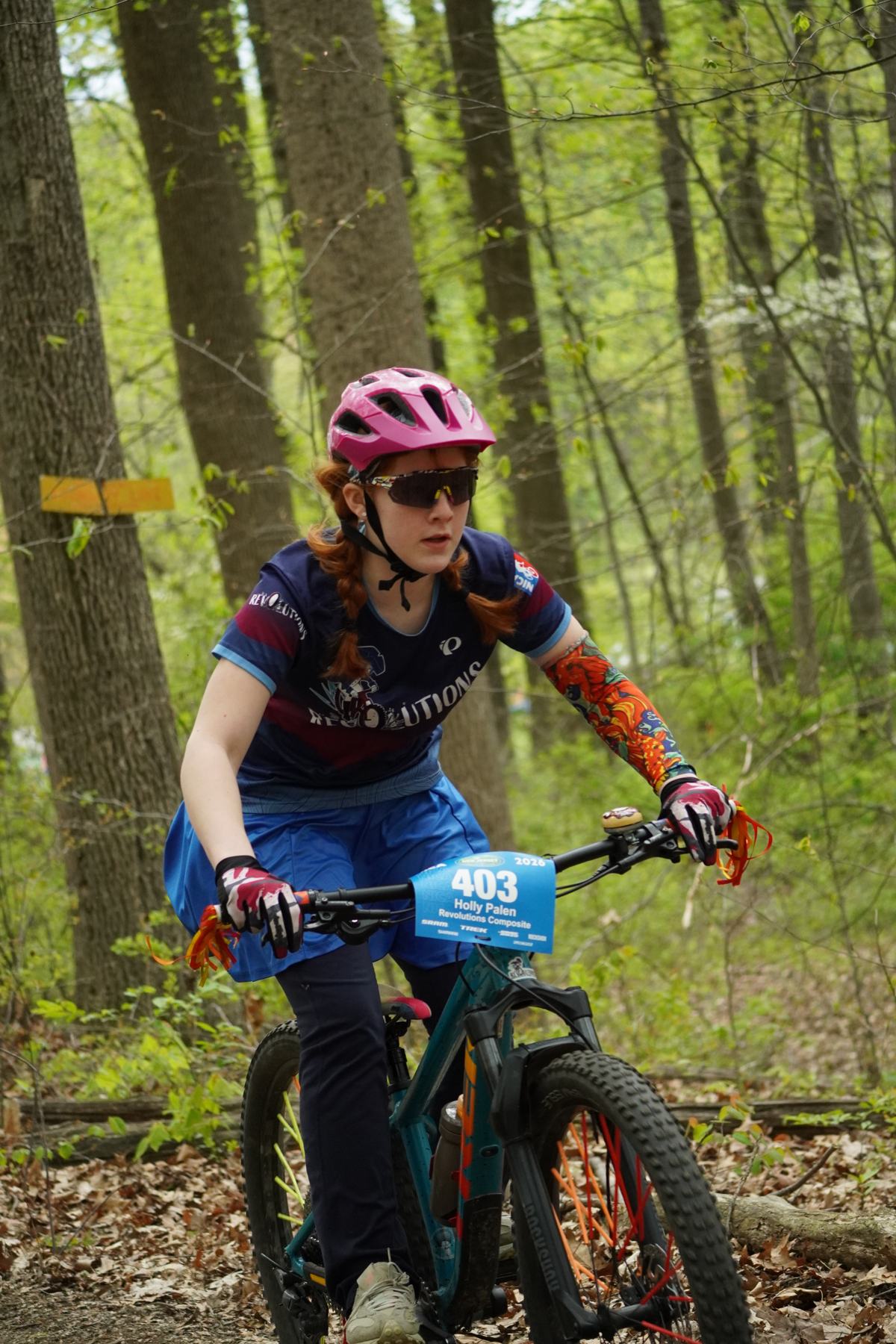 Rider in a pink helmet on a spring trail