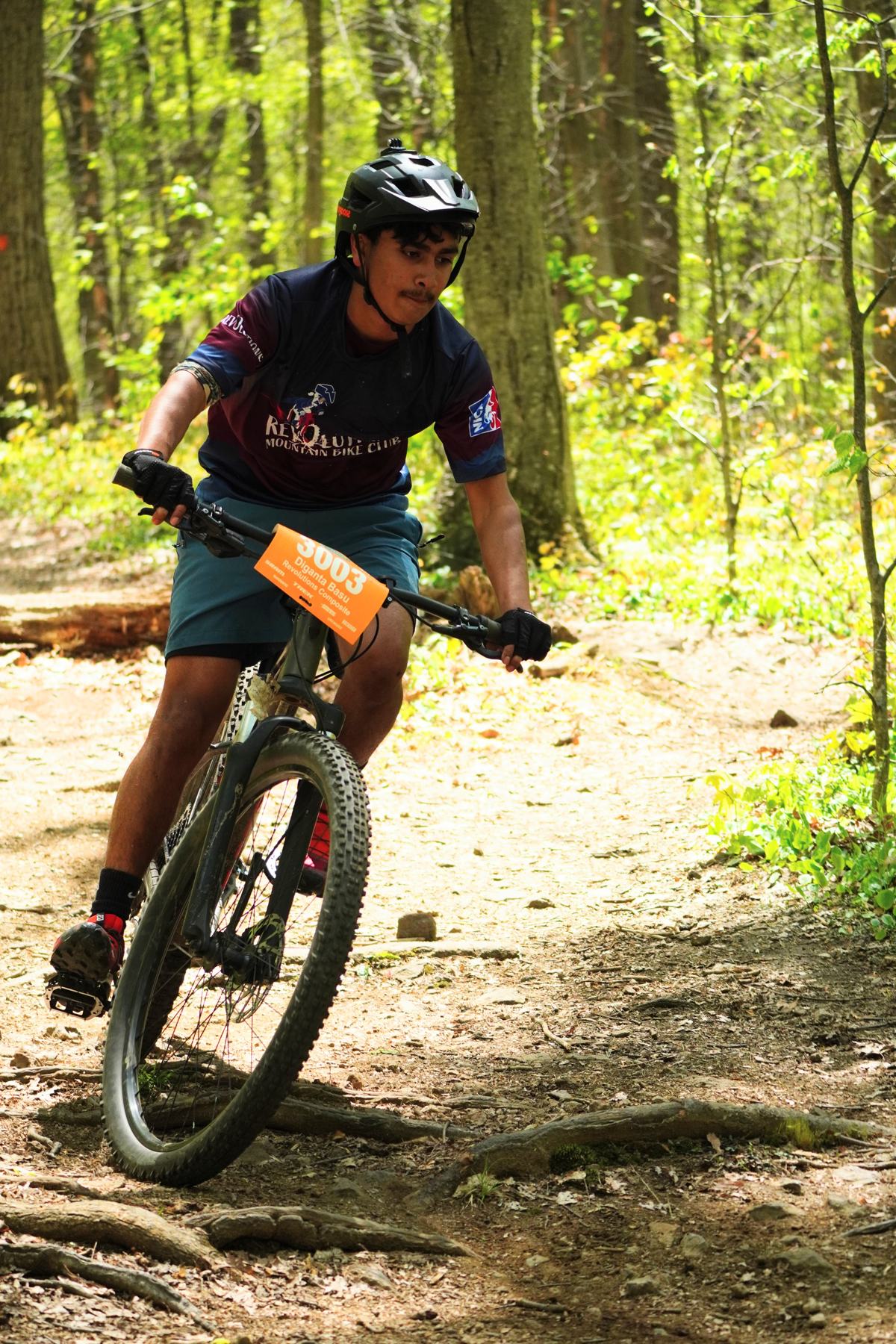 Rider cornering on a sunlit trail