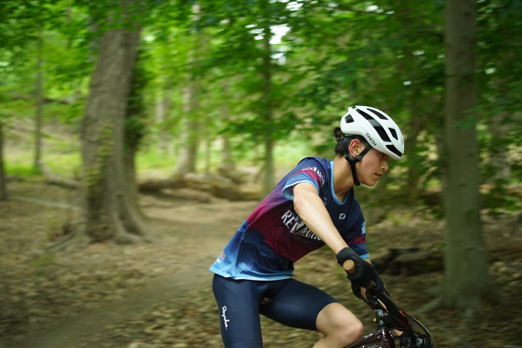Rider flying down a shaded trail
