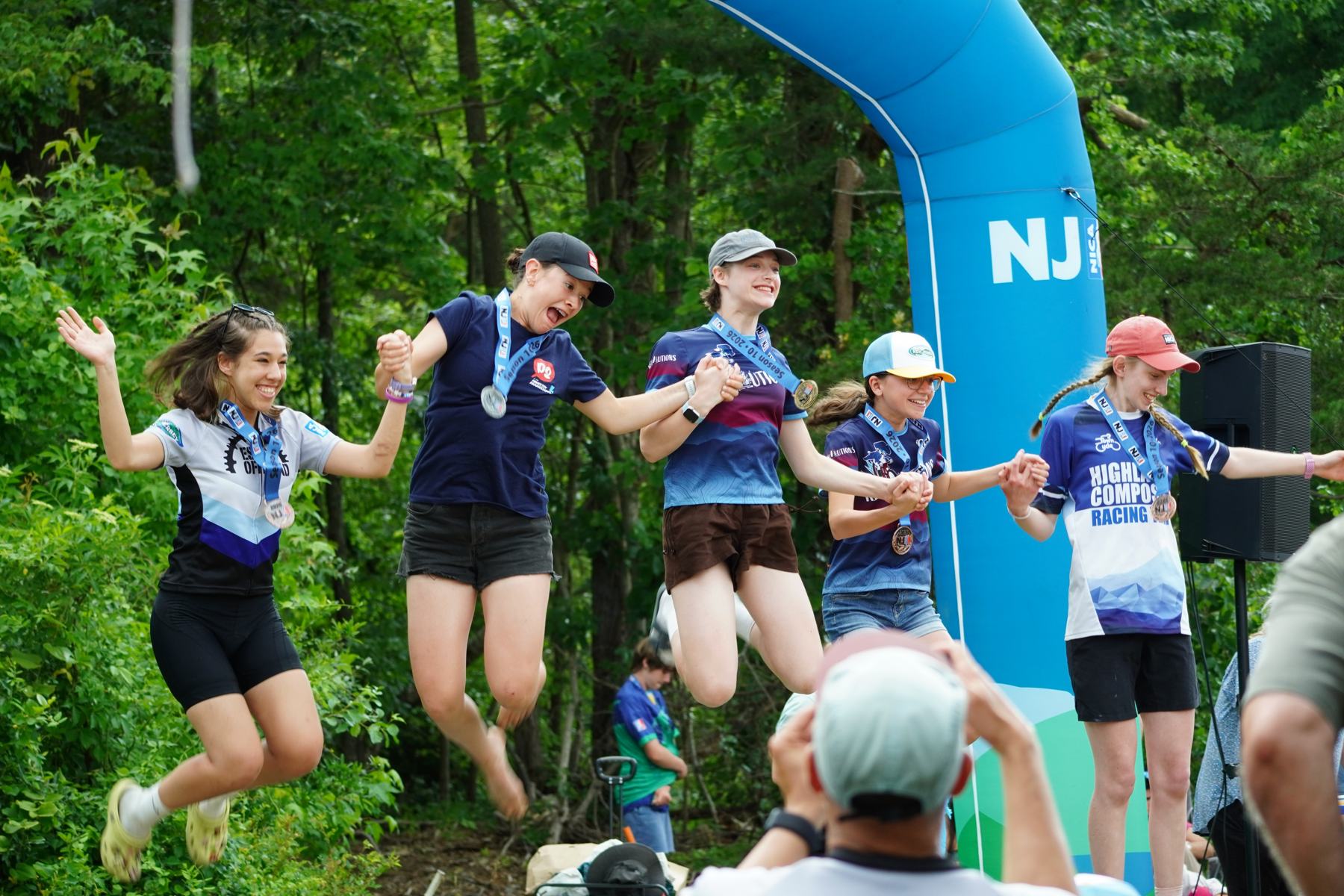 Riders celebrating at the finish arch