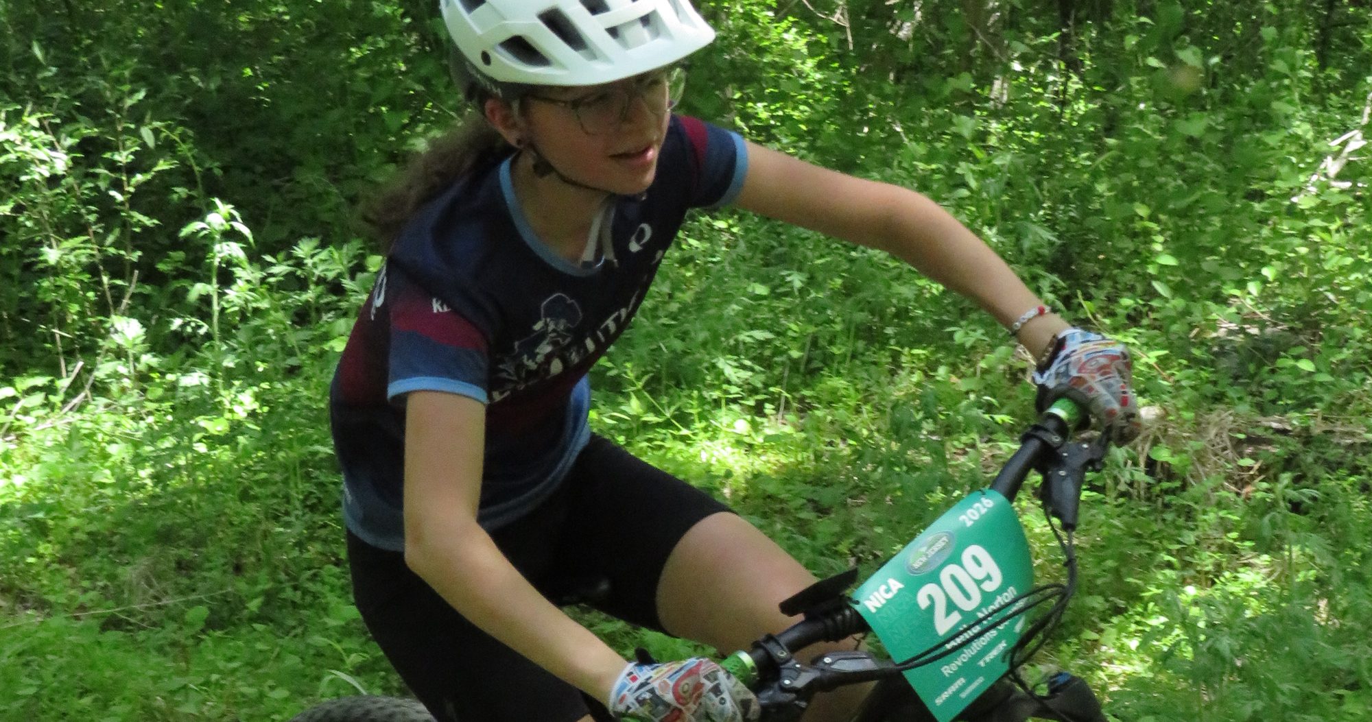 Rider on green singletrack