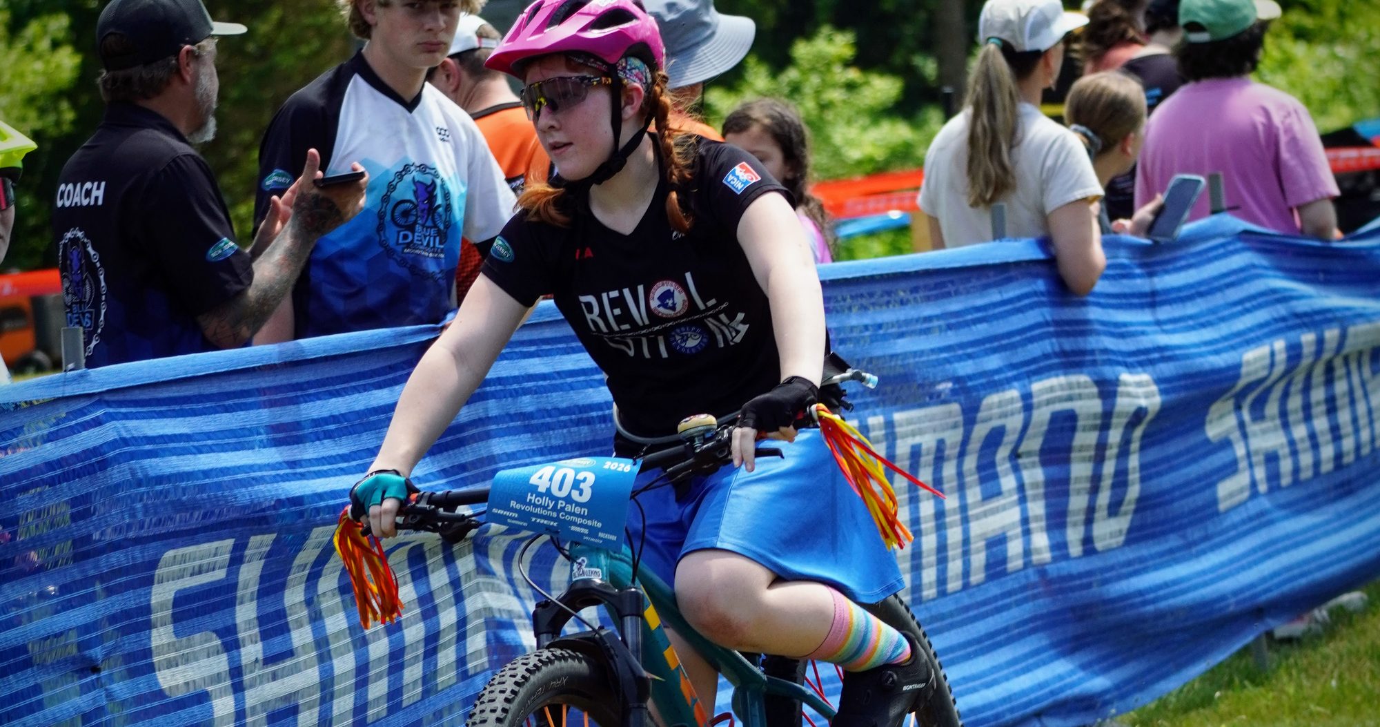 Rider coming past the tape with the crowd behind